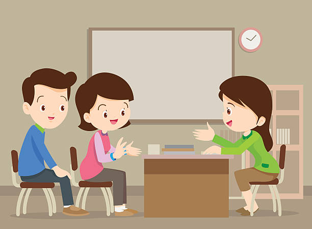Parent meeting with teacher in classroom.